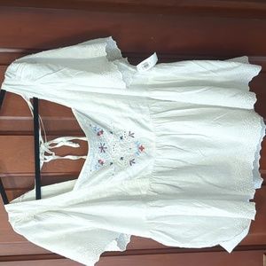 White eyelet top with red and blue embroidery